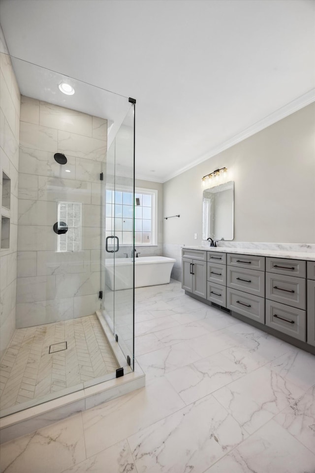 bathroom featuring ornamental molding, independent shower and bath, and vanity