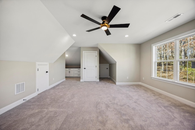 bonus room featuring ceiling fan, vaulted ceiling, and light carpet