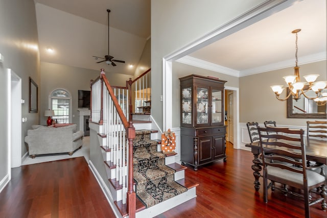 interior space featuring ceiling fan with notable chandelier, crown molding, hardwood / wood-style floors, and high vaulted ceiling