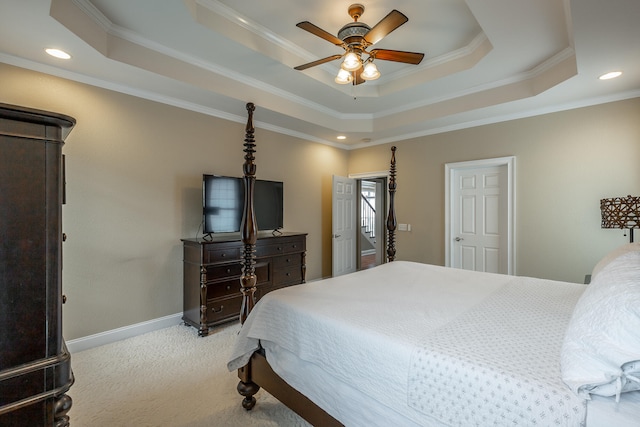 bedroom featuring ceiling fan, light colored carpet, a raised ceiling, and crown molding