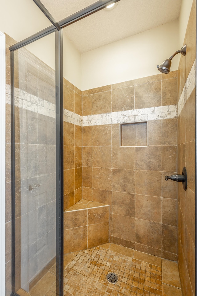 bathroom with a shower with door