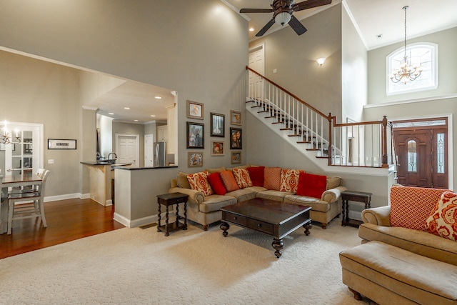 living room with crown molding, hardwood / wood-style floors, and a high ceiling