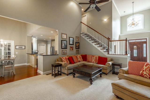 106 Woodpecker Pl, Ringgold, GA 30736 - living room featuring baseboards, ornamental molding, stairway, a high ceiling, and ceiling fan with notable chandelier