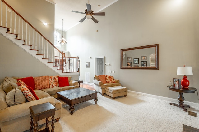 living room with ceiling fan with notable chandelier, a high ceiling, and carpet flooring