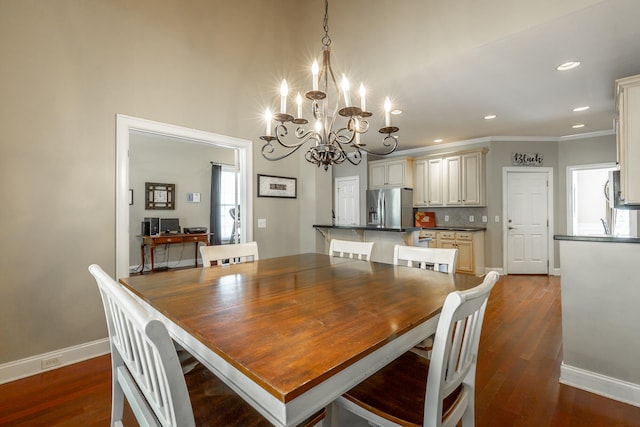 dining room featuring ornamental molding, an inviting chandelier, and dark wood-type flooring