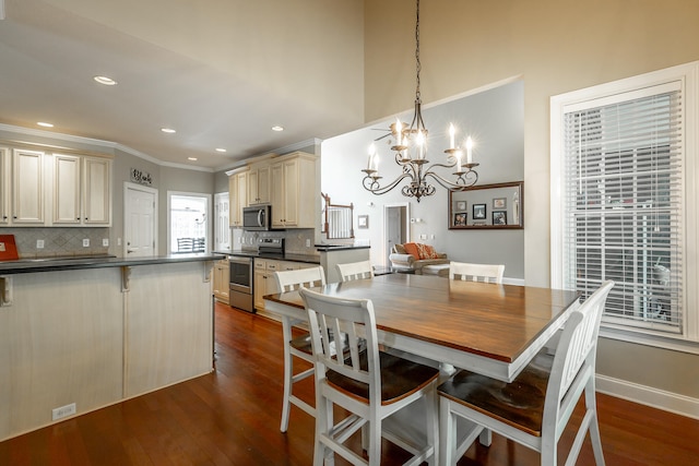 dining room with a notable chandelier, dark hardwood / wood-style floors, and ornamental molding