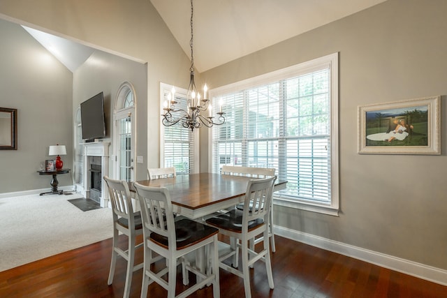 dining space featuring a notable chandelier, dark hardwood / wood-style flooring, high vaulted ceiling, and a wealth of natural light