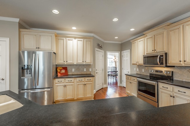 kitchen featuring ornamental molding, stainless steel appliances, light hardwood / wood-style flooring, and tasteful backsplash