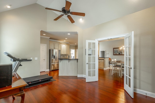 workout area with ceiling fan with notable chandelier, high vaulted ceiling, dark hardwood / wood-style floors, and french doors