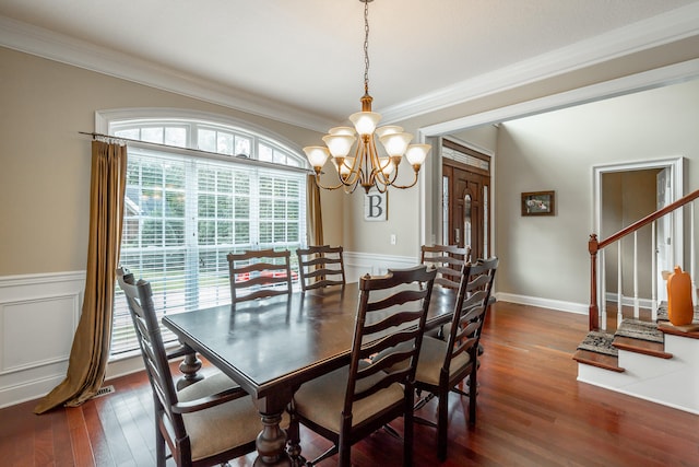 dining room with dark hardwood / wood-style floors, a chandelier, and crown molding