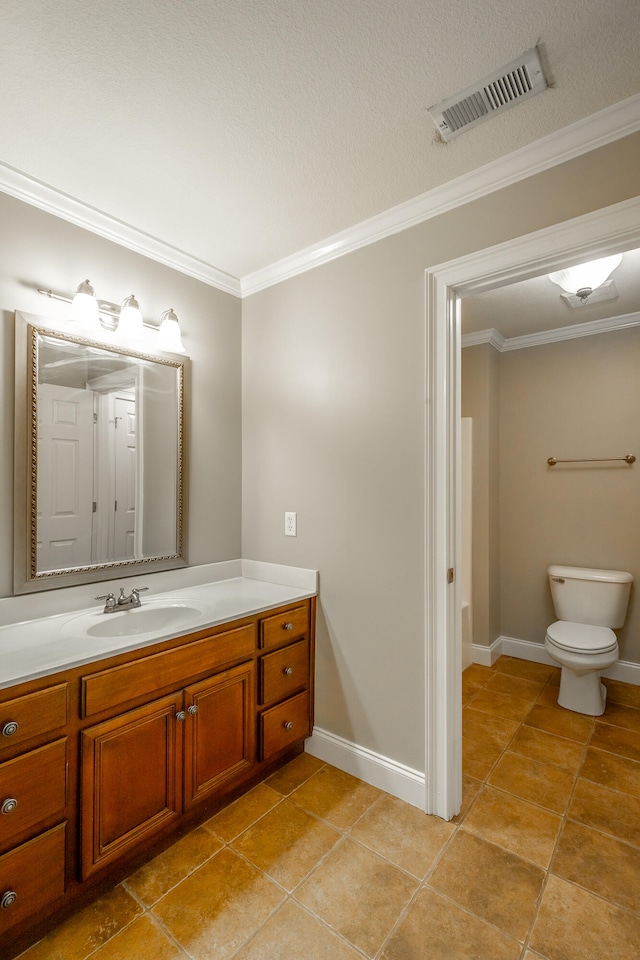 bathroom with tile patterned flooring, a textured ceiling, ornamental molding, vanity, and toilet