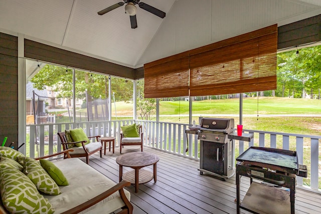 sunroom featuring lofted ceiling and ceiling fan