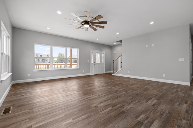 unfurnished living room with ceiling fan and dark hardwood / wood-style flooring