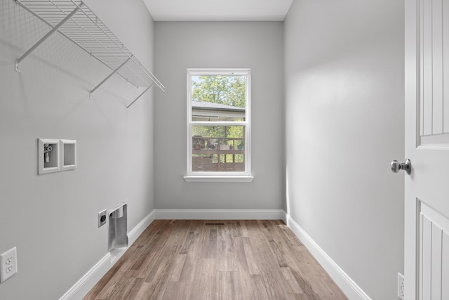 laundry area featuring light hardwood / wood-style flooring and electric dryer hookup