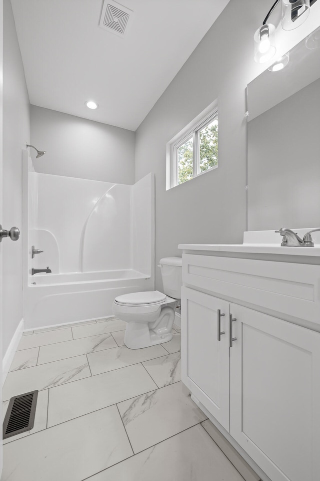 full bathroom featuring tub / shower combination, vanity, and toilet