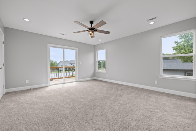 carpeted spare room featuring ceiling fan