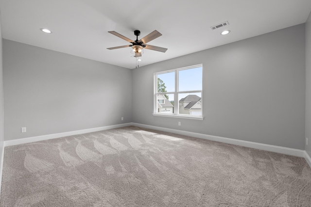 spare room featuring carpet flooring and ceiling fan