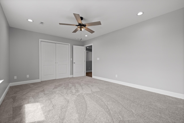 unfurnished bedroom featuring a closet, ceiling fan, and carpet flooring