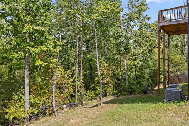 view of yard featuring a wooden deck and central air condition unit