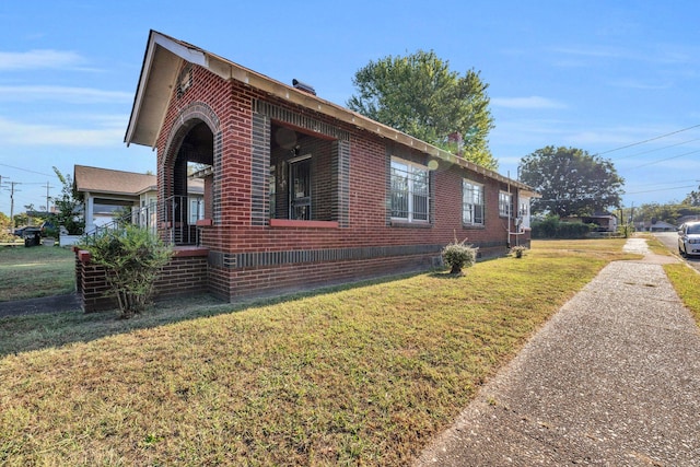 view of side of home featuring a yard