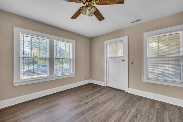 unfurnished room featuring dark wood-type flooring and ceiling fan