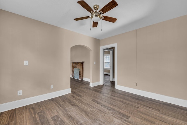 spare room with ceiling fan and dark hardwood / wood-style flooring