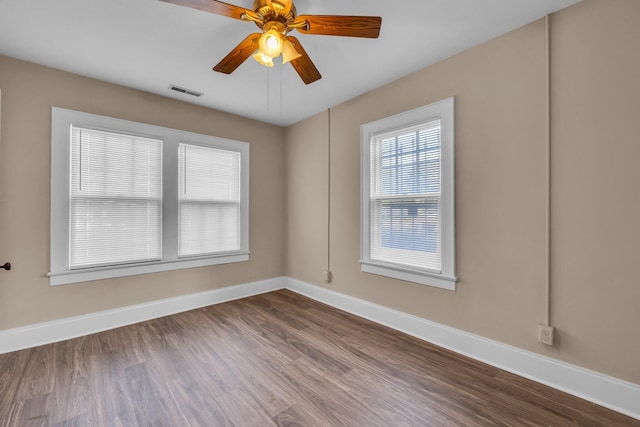 empty room with hardwood / wood-style flooring and ceiling fan