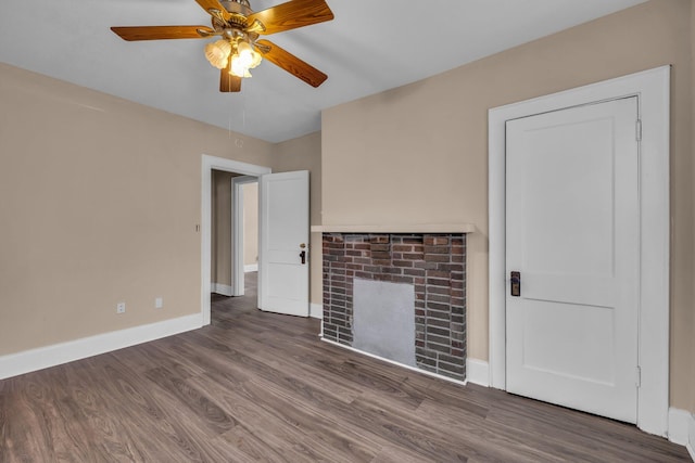 unfurnished living room featuring ceiling fan, a fireplace, and dark hardwood / wood-style flooring