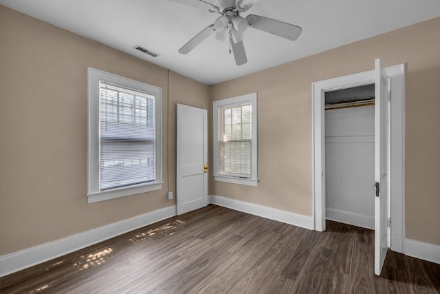 unfurnished bedroom with a closet, ceiling fan, and dark hardwood / wood-style floors