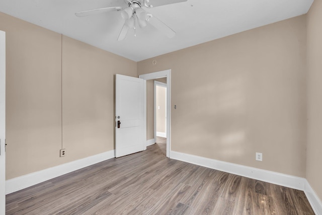 empty room featuring hardwood / wood-style floors and ceiling fan