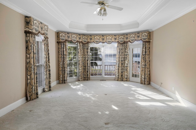 unfurnished room with ceiling fan, a tray ceiling, and crown molding