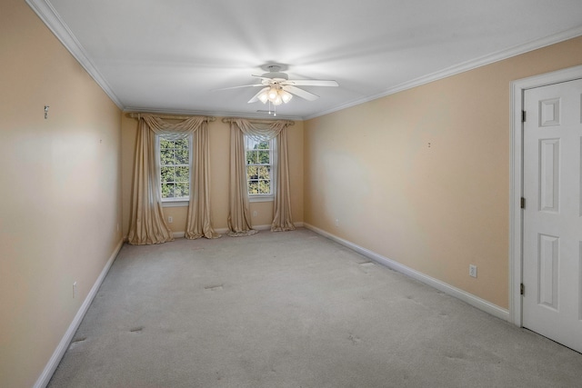 carpeted empty room featuring ceiling fan and ornamental molding