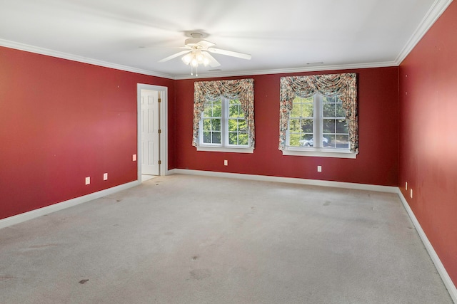 carpeted empty room with ceiling fan and ornamental molding