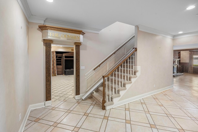 staircase with crown molding and tile patterned floors