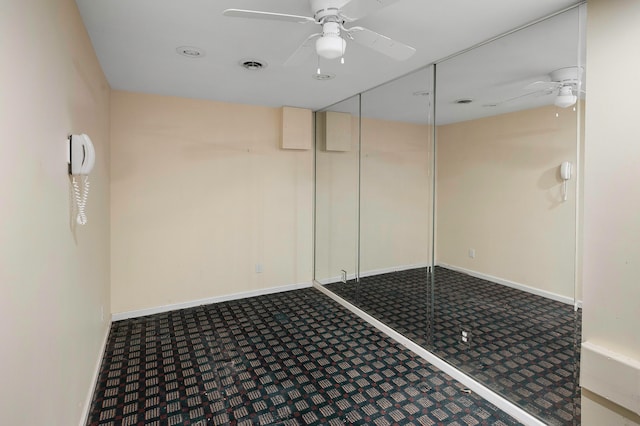 carpeted empty room featuring ceiling fan