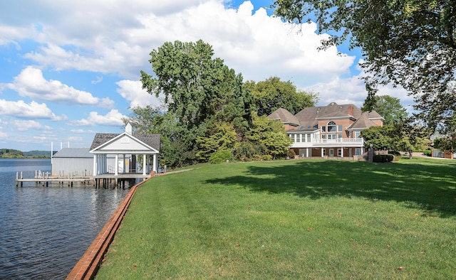 view of yard featuring a boat dock and a water view