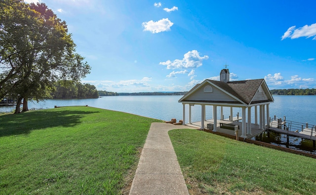 dock area with a yard and a water view