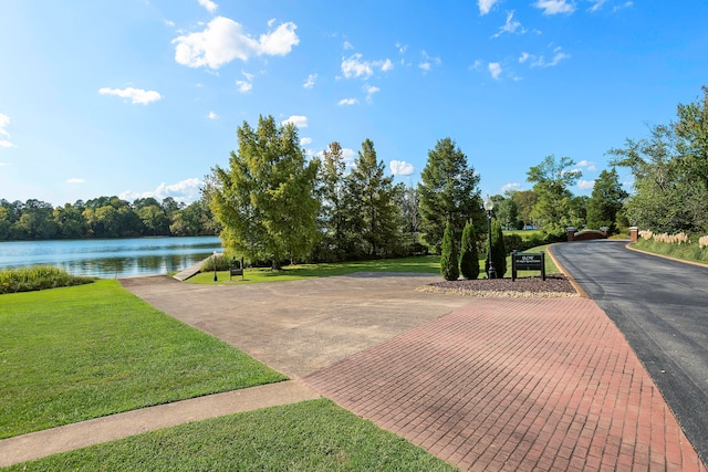 exterior space with a lawn and a water view