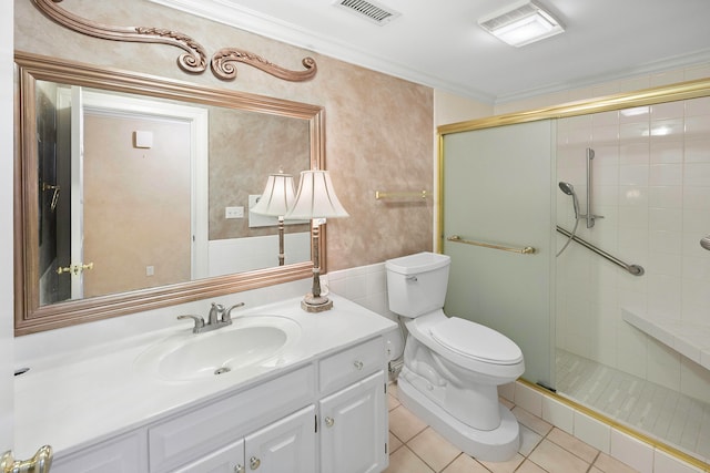 bathroom with vanity, toilet, crown molding, tile patterned flooring, and a shower with door