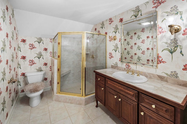 bathroom with vanity, toilet, tile patterned floors, and a shower with door