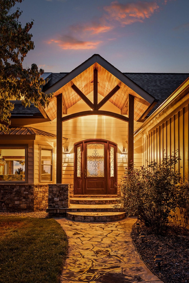 view of exterior entry at dusk