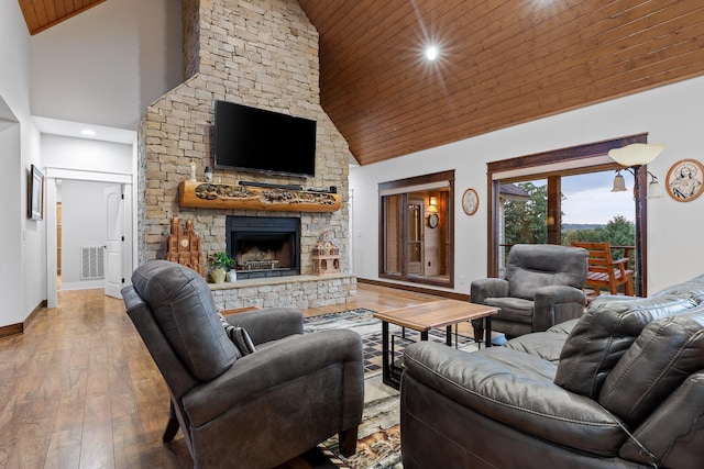 living room featuring high vaulted ceiling, wood ceiling, hardwood / wood-style floors, and a fireplace