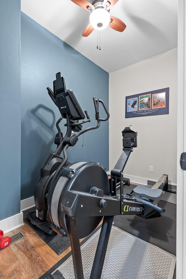 workout room featuring ceiling fan and hardwood / wood-style flooring