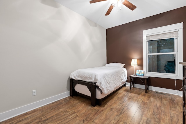 bedroom featuring ceiling fan and hardwood / wood-style floors