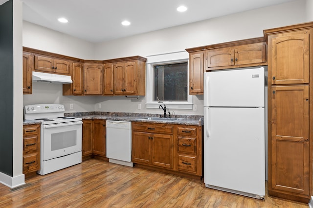 kitchen featuring white appliances, dark hardwood / wood-style floors, and sink