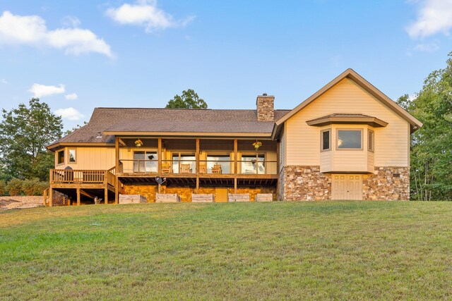 back of property featuring a lawn and a deck