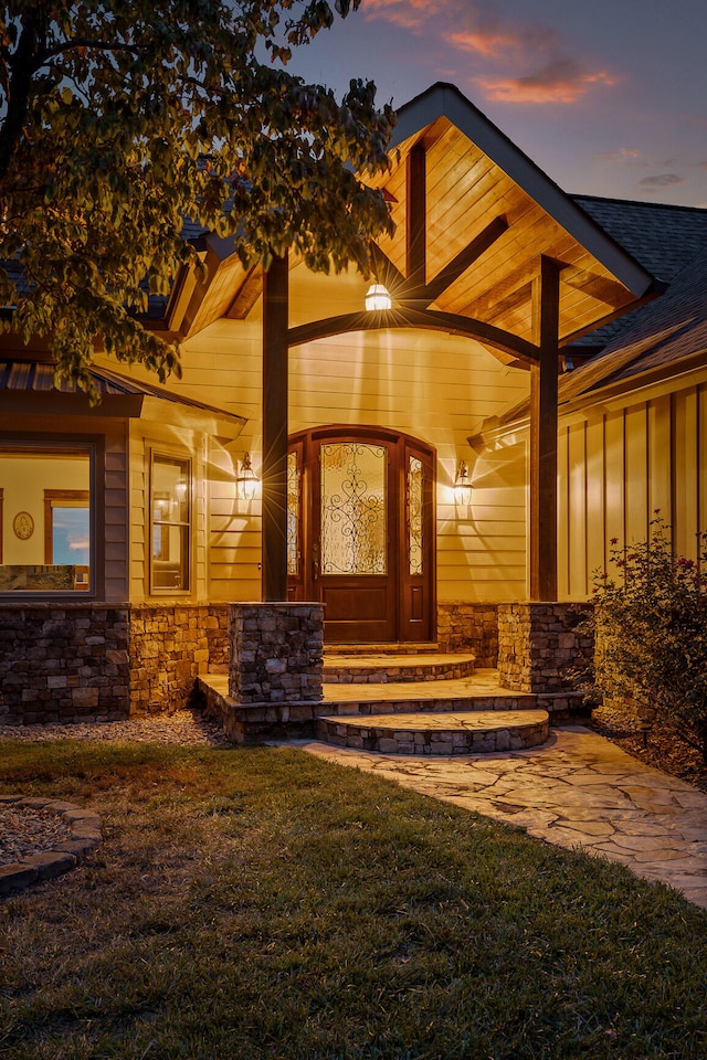 exterior entry at dusk with a yard