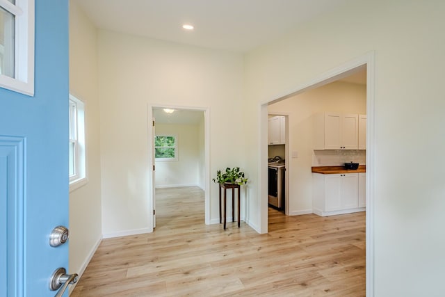 corridor with baseboards, light wood-style flooring, and recessed lighting