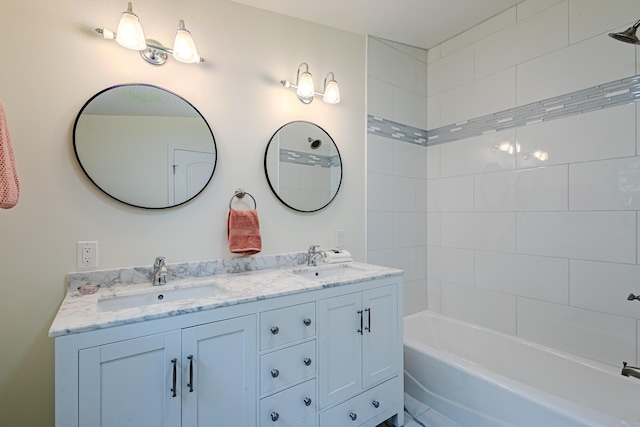 full bath with double vanity, bathing tub / shower combination, and a sink