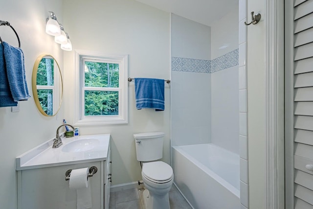 bathroom featuring toilet, vanity, tile patterned floors, and baseboards